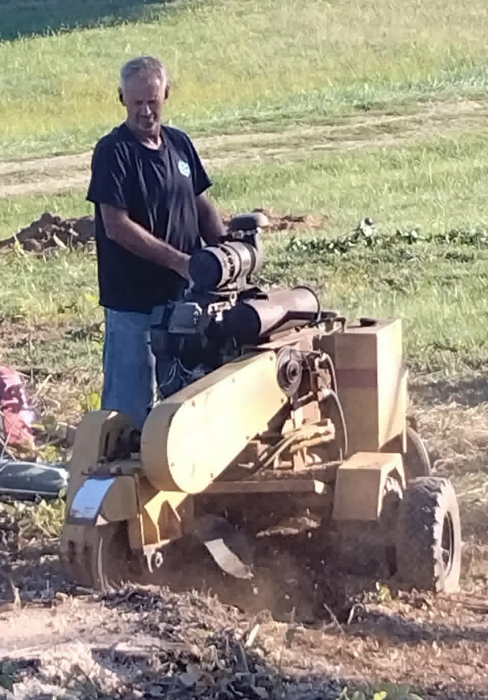 Operator running a stump grinder through fresh chips